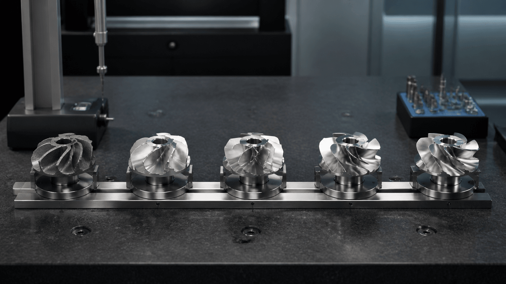 Five machined components aligned through a controlled inspection sequence